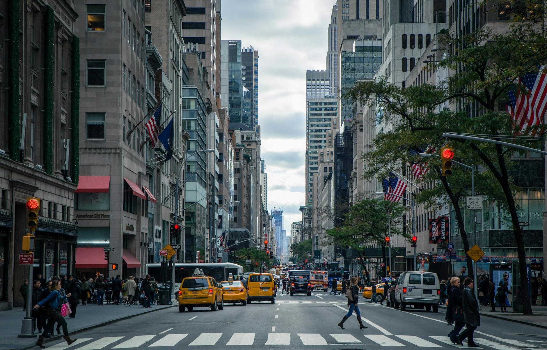 Vibrant street view of New York City with pedestrians, yellow cabs, and skyscrapers. Vibrant street view of New York City with pedestrians, yellow cabs, and skyscrapers.