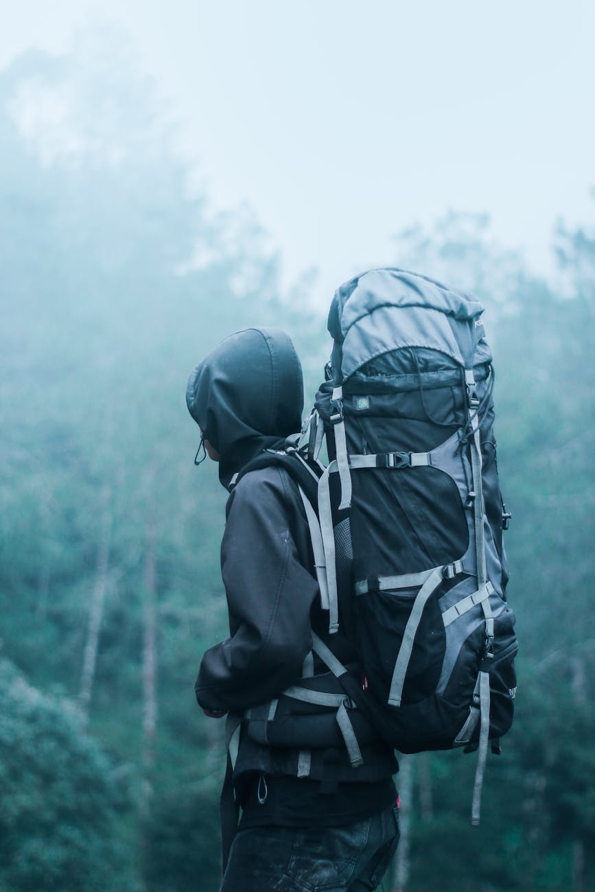 Solo hiker with large backpack in a misty forest, exploring nature’s serene beauty. Solo hiker with large backpack in a misty forest, exploring nature’s serene beauty.